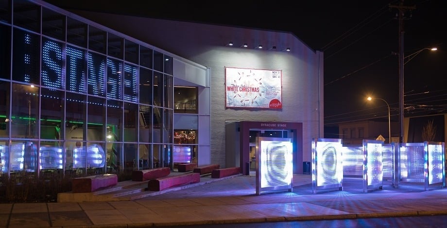 Night view of the front of Syracuse Stage's building